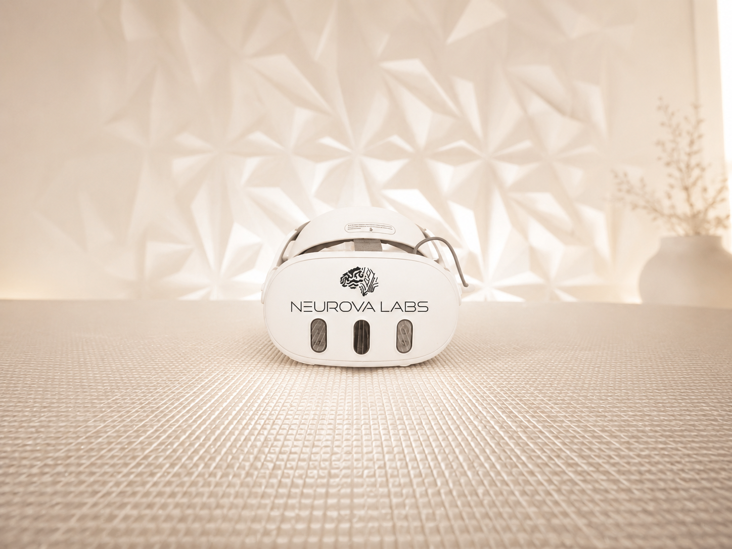 A white Neurova Labs virtual reality headset resting on a mat in a quiet, softly lit room